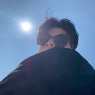 Yihan Zhu outdoors beneath a blue sky